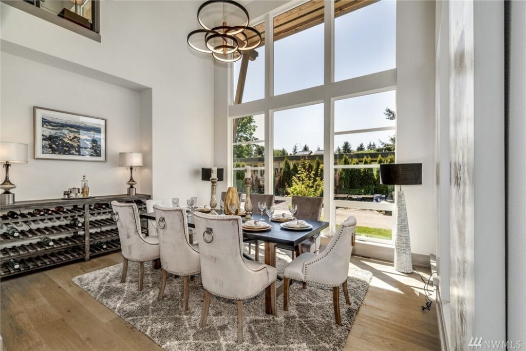 Dining Room Dining room featuring large floor-to-ceiling windows and tall ceilings. With home design by Seattle architectural firm Architectural innovations