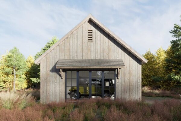 A wooden barn-style garage with a peaked roof sits among tall grasses and trees; through large glass doors, a green vintage vehicle is visible inside, showcasing the versatility of a DADU Floor Plan.